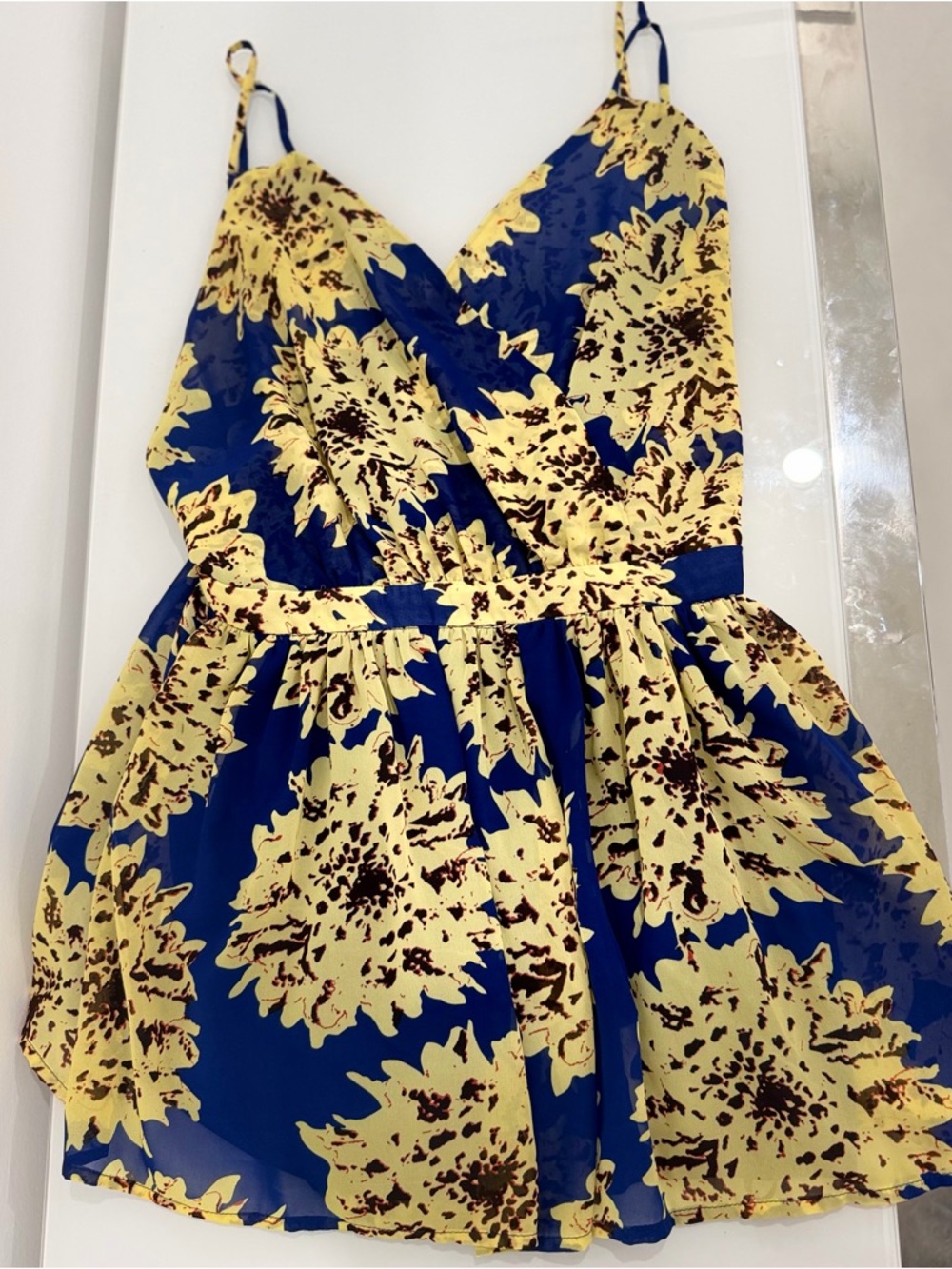Used once the clothing company Blue and Yellow Floral Romper